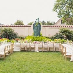 Photograph of several rows of chairs set up on the grass in Sculpture Garden